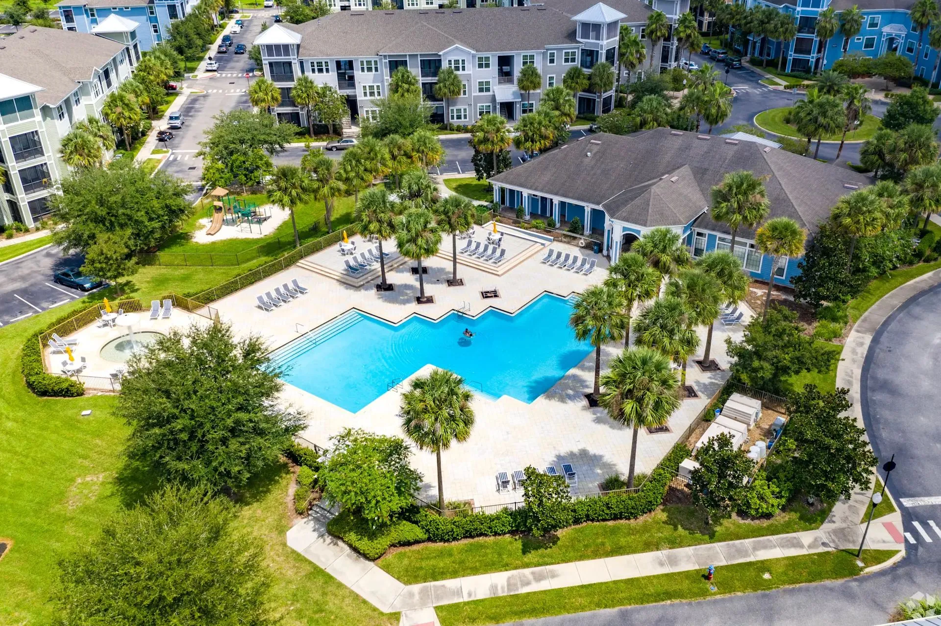 Pool and palm trees at The Glen at Cagan Crossings
