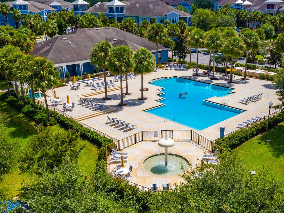 Aerial view of The Glen at Cagan Crossings pool, palm trees and apartment buildings